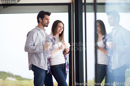 Image of relaxet young couple drink first morning coffee