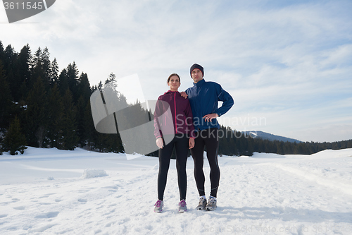 Image of couple jogging outside on snow