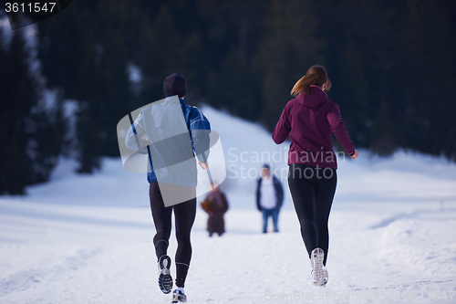 Image of couple jogging outside on snow