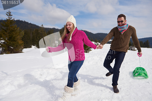 Image of happy young couple having fun on fresh show on winter vacation