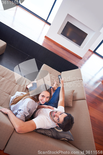 Image of young couple watching tv at home