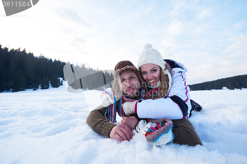 Image of couple having fun and walking in snow shoes