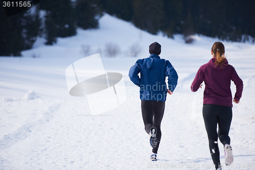 Image of couple jogging outside on snow