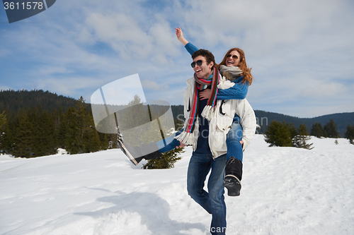Image of happy young couple having fun on fresh show on winter vacation