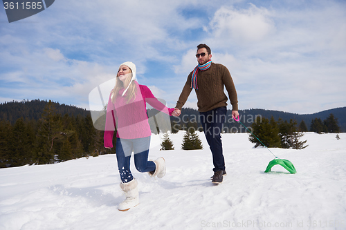 Image of happy young couple having fun on fresh show on winter vacation