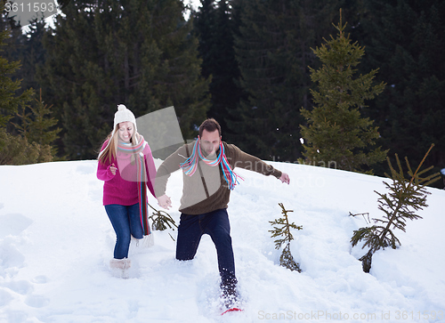 Image of couple having fun and walking in snow shoes