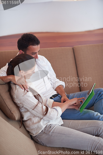 Image of couple at modern home using tablet computer