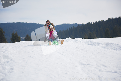 Image of happy young couple having fun on fresh show on winter vacation