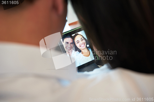 Image of couple at modern home using tablet computer