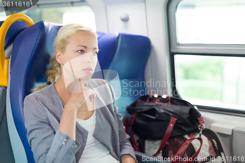 Image of Blonde business woman traveling by train.