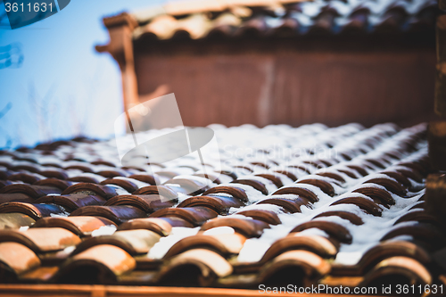 Image of snow on red tiled roof