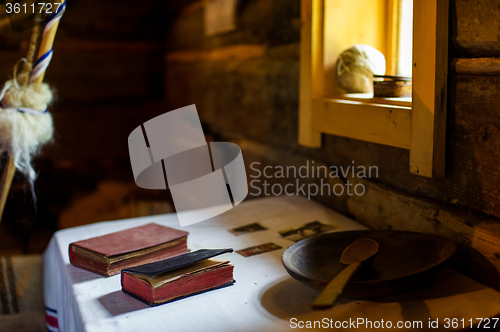 Image of Rural vintage wood kitchen table with books and cooking utensils around 