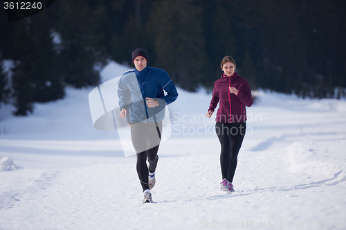 Image of couple jogging outside on snow