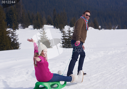 Image of happy young couple having fun on fresh show on winter vacation