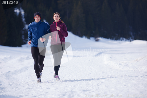 Image of couple jogging outside on snow