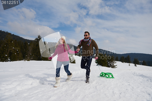 Image of happy young couple having fun on fresh show on winter vacation