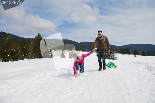 Image of happy young couple having fun on fresh show on winter vacation