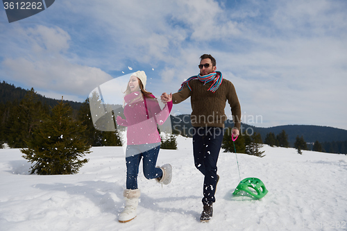 Image of happy young couple having fun on fresh show on winter vacation