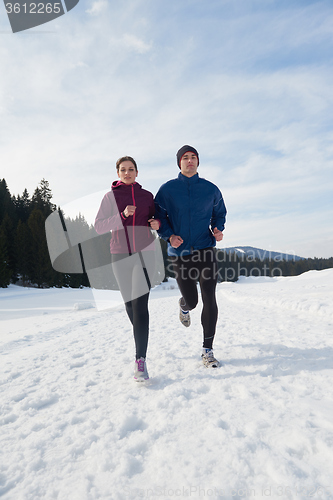 Image of couple jogging outside on snow