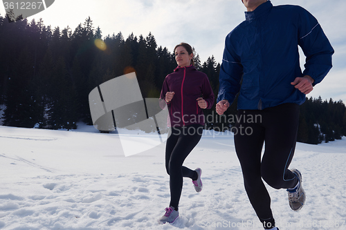 Image of couple jogging outside on snow
