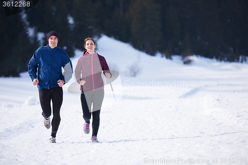 Image of couple jogging outside on snow