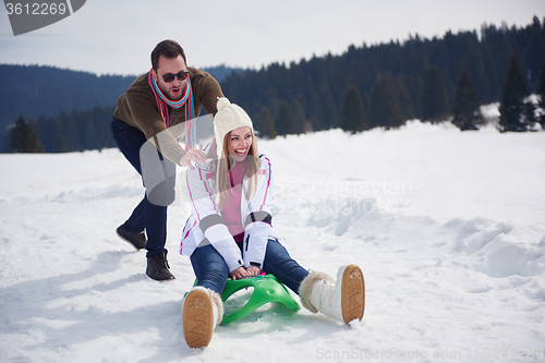 Image of happy young couple having fun on fresh show on winter vacation