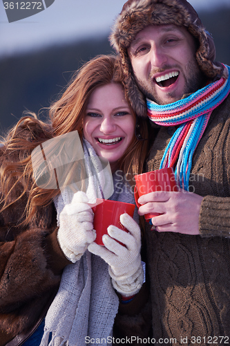 Image of couple drink warm tea at winter