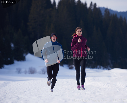 Image of couple jogging outside on snow