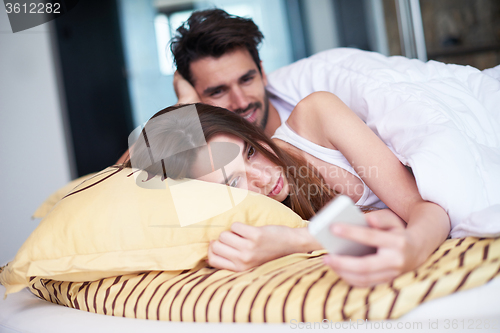 Image of couple relax and have fun in bed