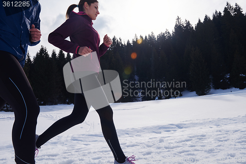 Image of couple jogging outside on snow