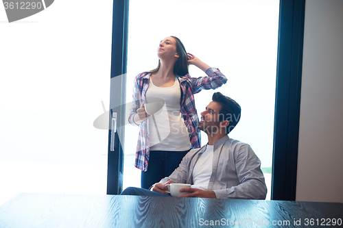 Image of relaxet young couple drink first morning coffee