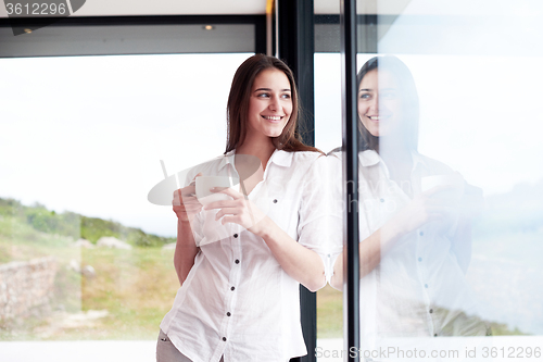 Image of beautiful young woman drink first morning coffee