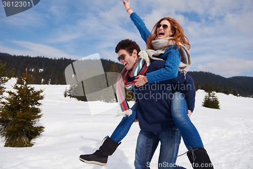 Image of happy young couple having fun on fresh show on winter vacation