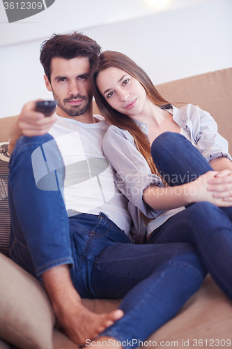 Image of young couple watching tv at home