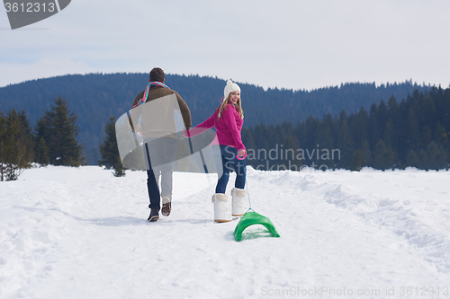 Image of happy young couple having fun on fresh show on winter vacation