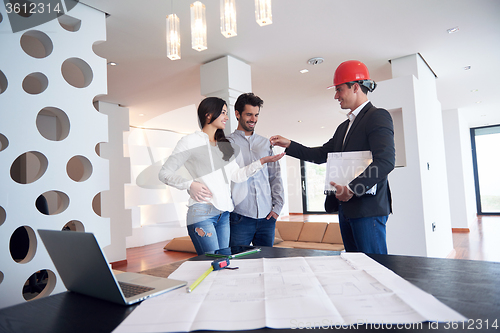 Image of couple buying new home with real estate agent