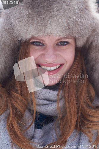 Image of portrait of beautiful young redhair woman in snow scenery