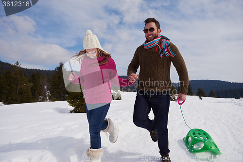 Image of happy young couple having fun on fresh show on winter vacation