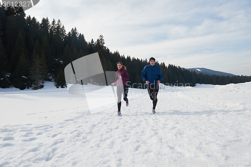 Image of couple jogging outside on snow