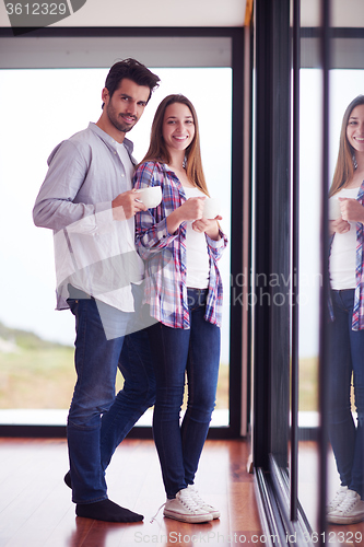 Image of relaxet young couple drink first morning coffee