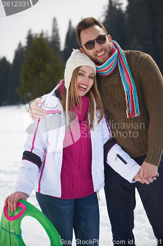 Image of happy young couple having fun on fresh show on winter vacation