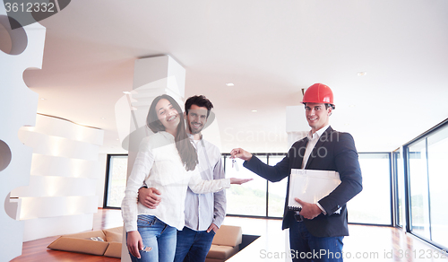 Image of couple buying new home with real estate agent