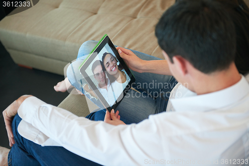 Image of couple at modern home using tablet computer