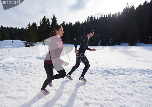 Image of couple jogging outside on snow