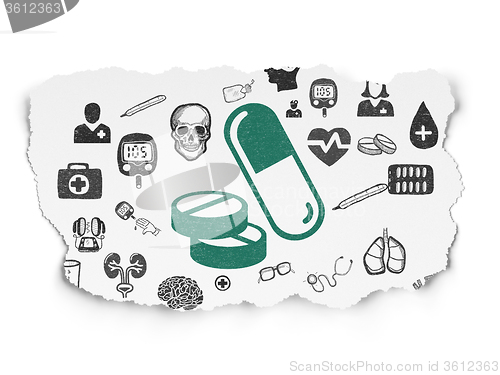 Image of Health concept: Pills on Torn Paper background