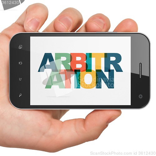 Image of Law concept: Hand Holding Smartphone with Arbitration on  display