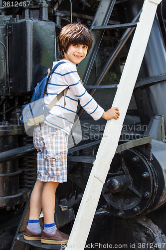 Image of child-researcher on the stairs of an old steam locomotive