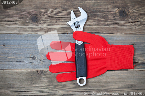 Image of Red construction glove with wrench