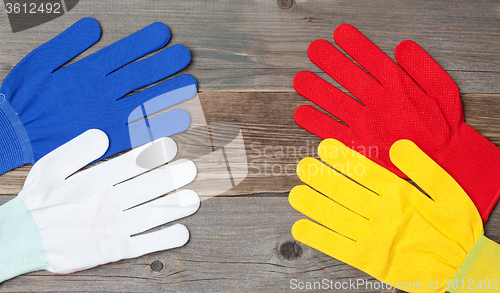 Image of four new working multicolored gloves