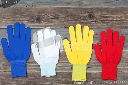 Image of working multicolored gloves